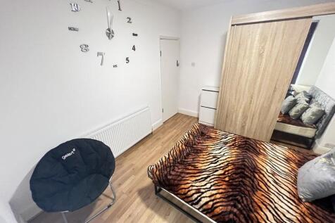 Cozy double bedroom featuring a stylish tiger-s...