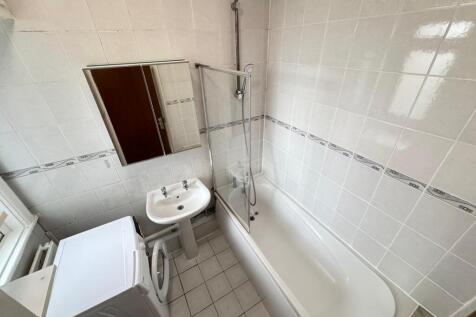 Bright and clean bathroom featuring a large bat...