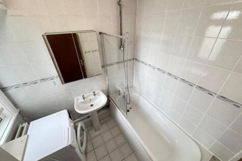 Well-maintained bathroom featuring a clean whit...