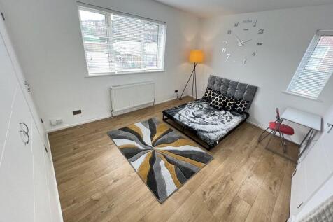 Bright and modern double bedroom featuring a st...