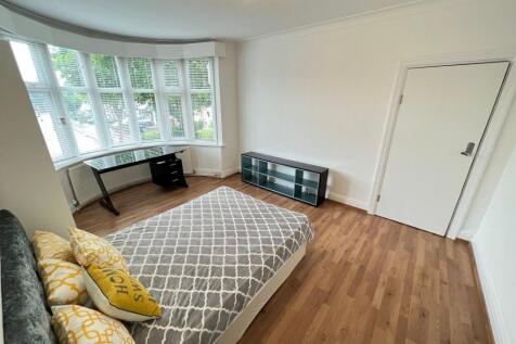 Bright and spacious master bedroom featuring a ...