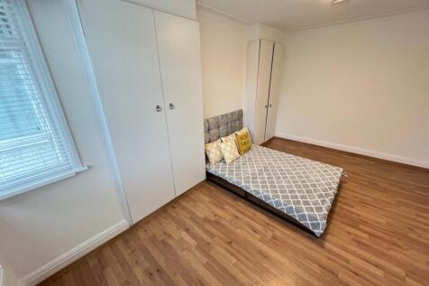 Bright and tidy double bedroom featuring wood-e...