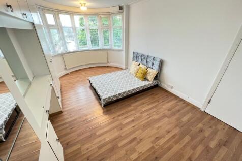 A bright and airy double bedroom featuring a la...