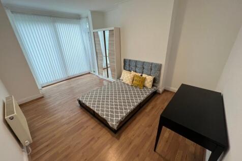 A neat and bright double bedroom featuring a co...