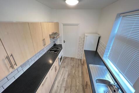 Bright and clean kitchen featuring modern light...