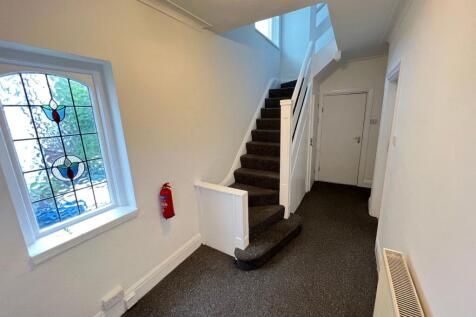 A clean and well-maintained hallway featuring a...