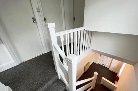 A clean and well-maintained staircase area with...