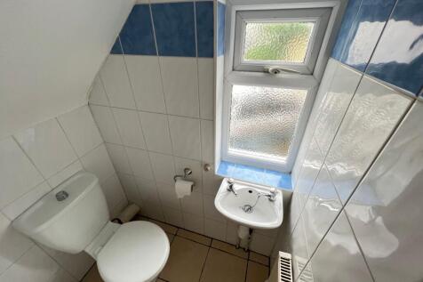 Compact and tidy toilet room featuring a clean ...
