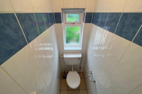 Bright and clean single toilet room featuring w...