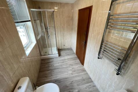 A clean, modern bathroom featuring a spacious s...