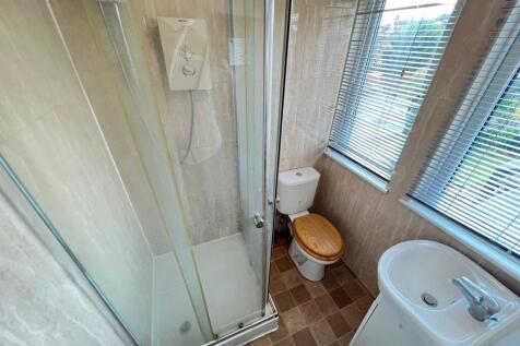 Bright bathroom featuring a modern shower cubic...