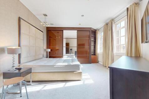 Bright and spacious master bedroom featuring a ...