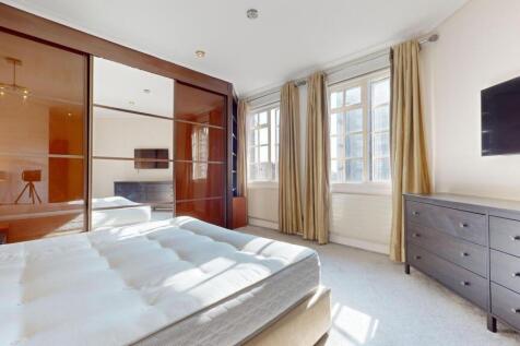 Bright and spacious master bedroom featuring la...
