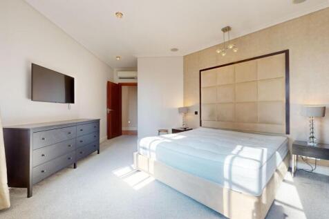 A bright and spacious master bedroom featuring ...