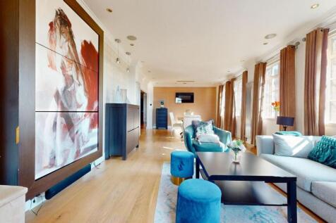 Bright and spacious living room featuring large...