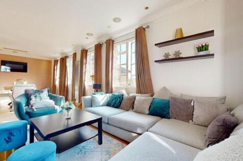 Bright and spacious living room featuring large...
