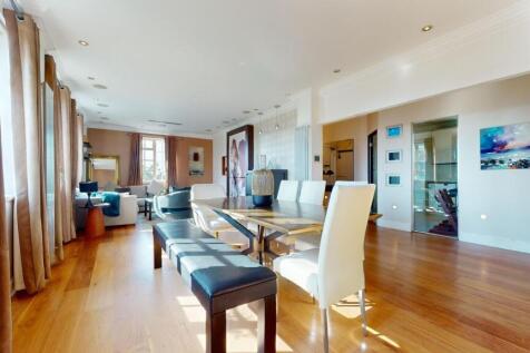 A spacious, sunlit living room featuring elegan...