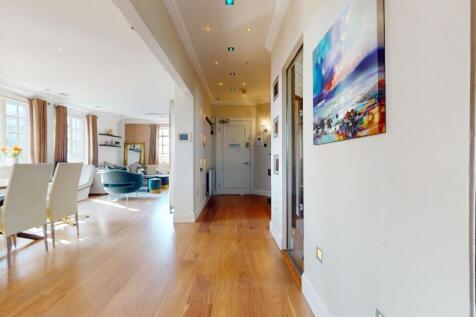 A bright and spacious living room featuring ele...