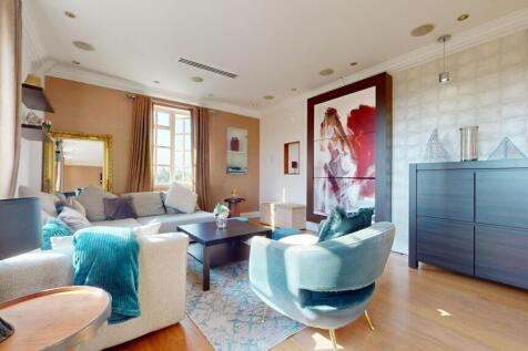 A bright and inviting living room featuring com...