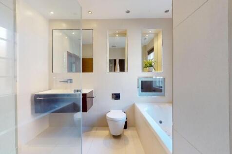 A sleek and modern bathroom suite featuring a l...