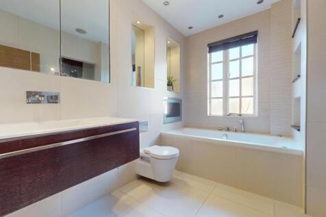 A modern and bright bathroom suite featuring a ...