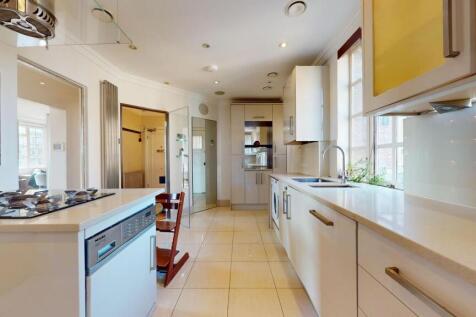 Bright and modern kitchen featuring sleek white...