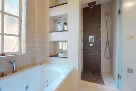 A bright and modern bathroom suite featuring a ...