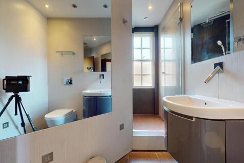 A modern bathroom suite featuring a spacious wa...