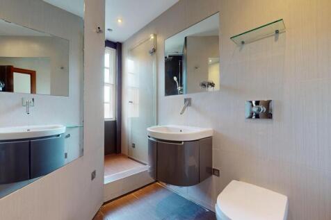 A modern and sleek bathroom featuring a wall-mo...