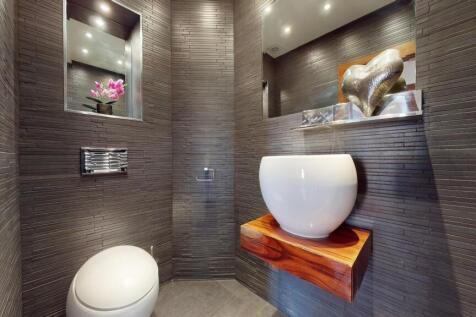 A modern and stylish single toilet room featuri...