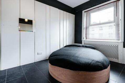 A stylish and well-lit double bedroom featuring...