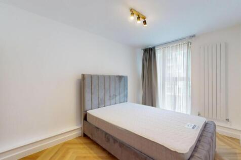 A bright and clean double bedroom featuring a l...