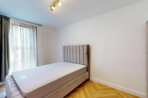A modern double bedroom featuring a comfortable...
