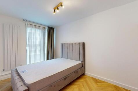 A bright and modern double bedroom featuring a ...