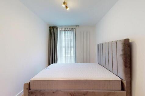 A modern double bedroom featuring a plush uphol...