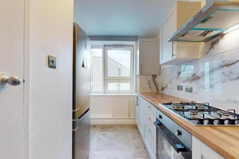 Bright and modern kitchen featuring sleek marbl...