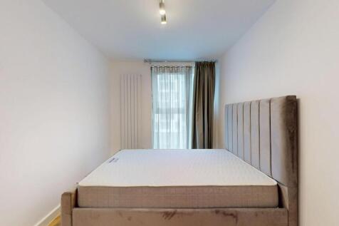 A modern double bedroom featuring a plush uphol...