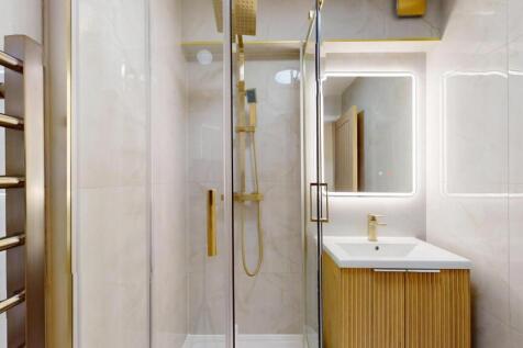 Modern bathroom featuring a sleek glass shower ...
