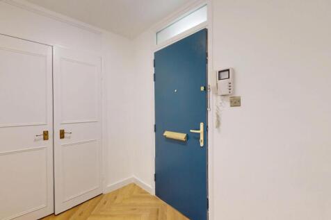 A bright and clean hallway featuring a bold blu...