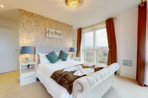 Bright and elegant master bedroom featuring a p...
