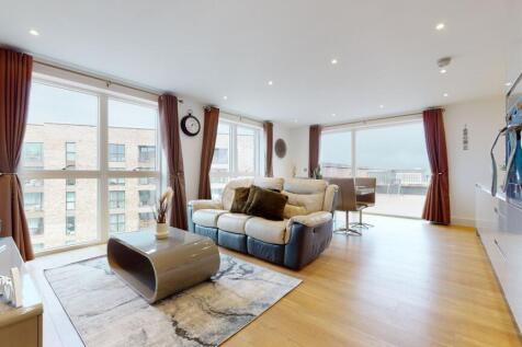 A spacious and modern living room featuring lar...