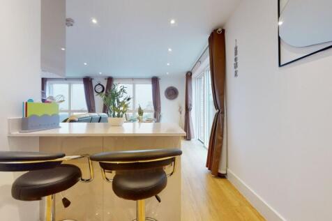 A bright and modern living room featuring large...