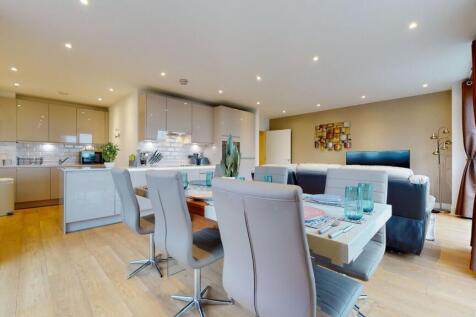 A modern, spacious open-plan living room and ki...