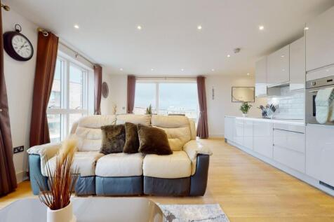 A modern and spacious living room with large wi...