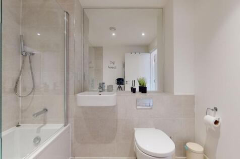 A modern and spotless bathroom suite featuring ...