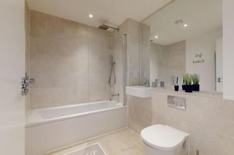 Bright and modern bathroom featuring a full bat...