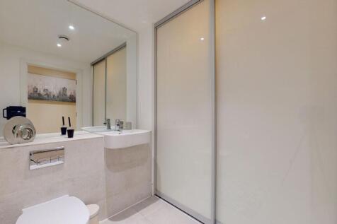 A modern bathroom suite featuring a sleek wall-...