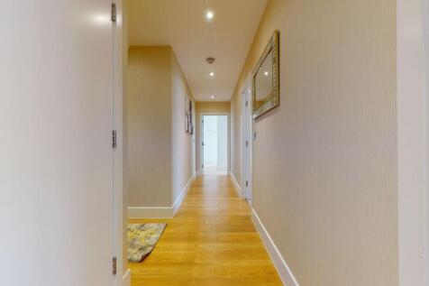 A bright and clean hallway with modern wooden f...