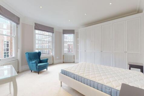 A bright and spacious master bedroom featuring ...