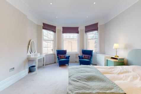 A spacious master bedroom featuring a large dou...